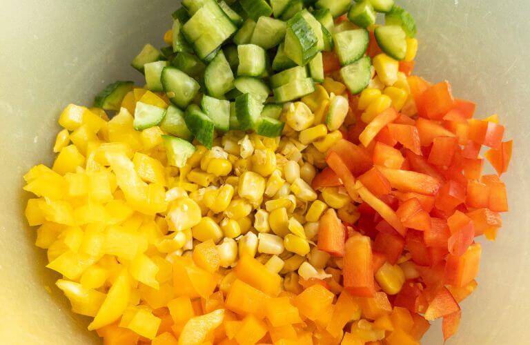 corn bell peppers and cucumber in yellow bowl