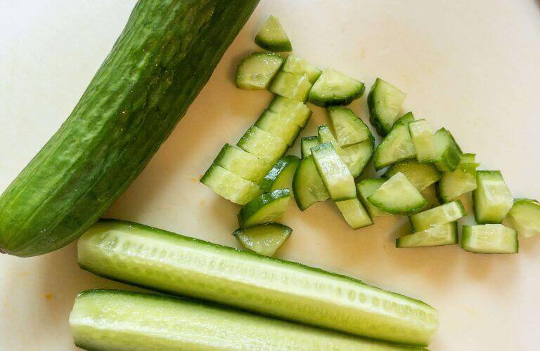 chopped cucumber on white cutting board