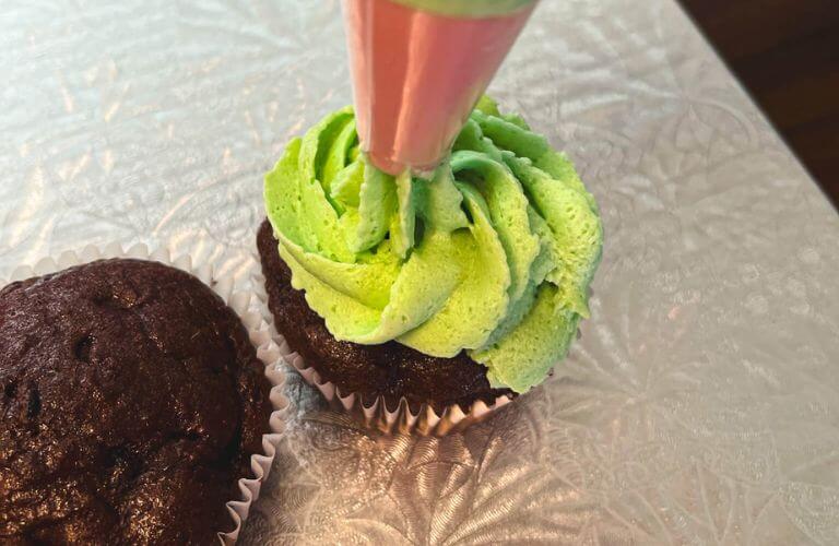 green icing on chocolate cupcake