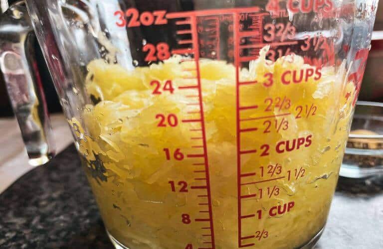 measuring cup with spaghetti squash shreds