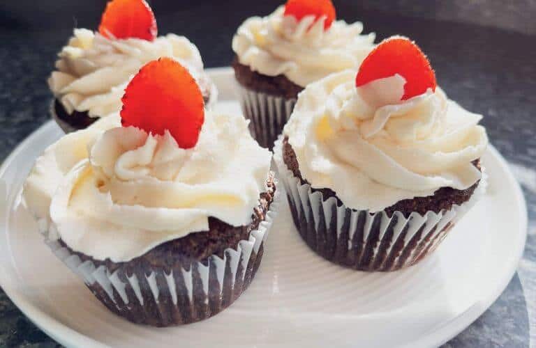 almond flour chocolate chips muffins with frosting and a strawberry topping