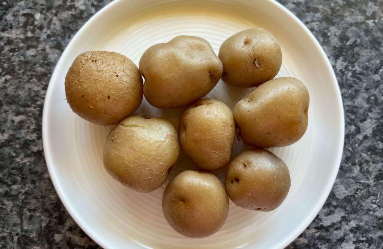 baby potatoes on white plate safe for gluten-sensitive individuals