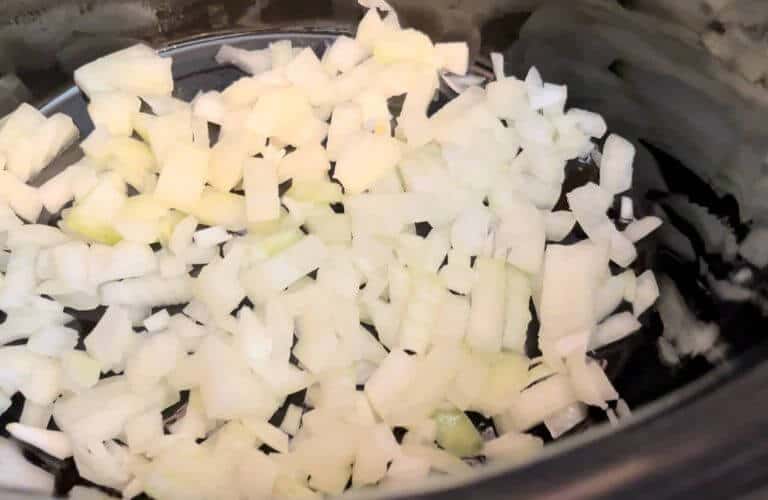 onions in slow cooker for celiac-friendly curry sauce
