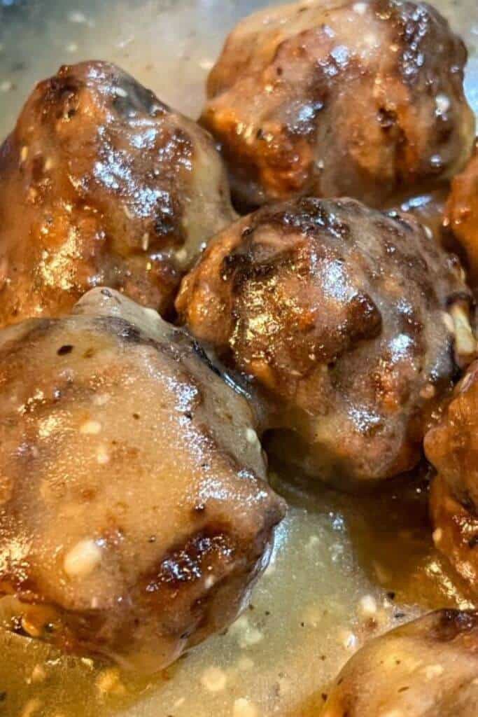 a close-up image of Easy lemon garlic sauce (gluten-free) poured over crispy turkey meatballs