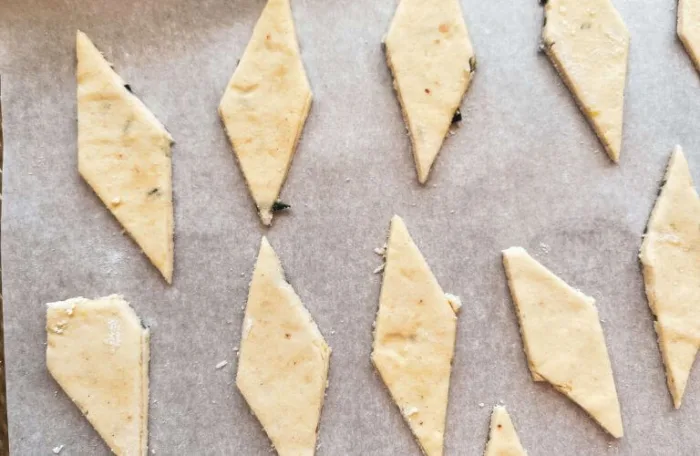 Gluten-free lemon rosemary sourdough discard cracker dough on cookie sheet ready for baking