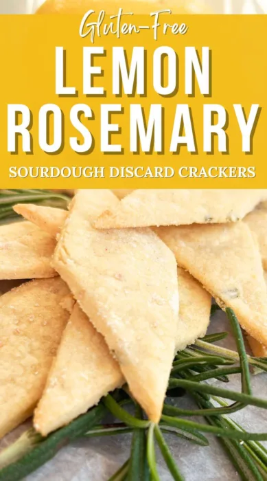 Close-up of gluten-free lemon rosemary sourdough discard crackers on a piece of parchment paper