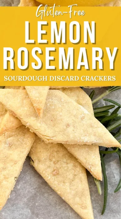 a close up of gluten-free lemon rosemary sourdough discard crackers being served with a sprig of fresh rosemary