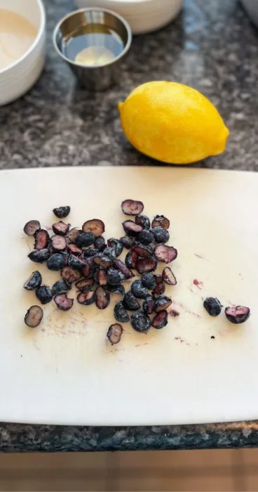 sliced blueberries on white cutting board for lemon blueberry gluten-free sourdough discard pancake recipe