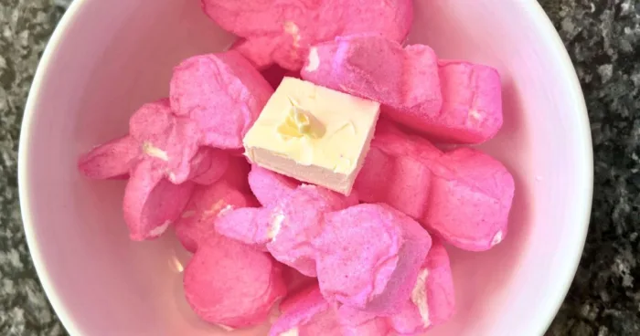 A close-up shot of colorful peeps arranged in a microwave-safe container, highlighting the vibrant hues as they prepare for a gluten-free baking experiment.