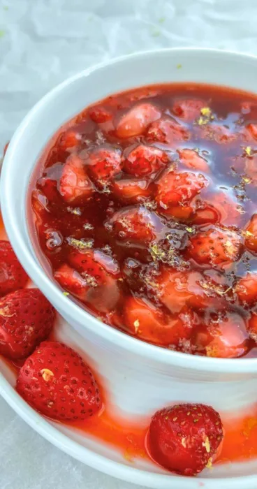 A sprinkle of bright lemon zest scattered over the decadent gluten-free strawberry sauce, offering a delightful contrast of flavors and textures.