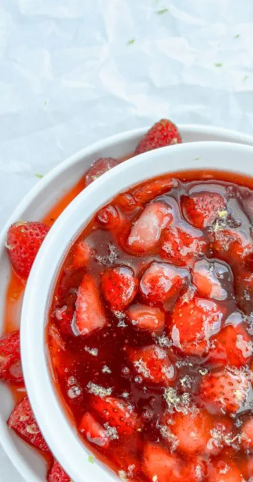 A close-up of garden strawberries blended into a silky gluten-free strawberry sauce, showcasing the variety of sizes.