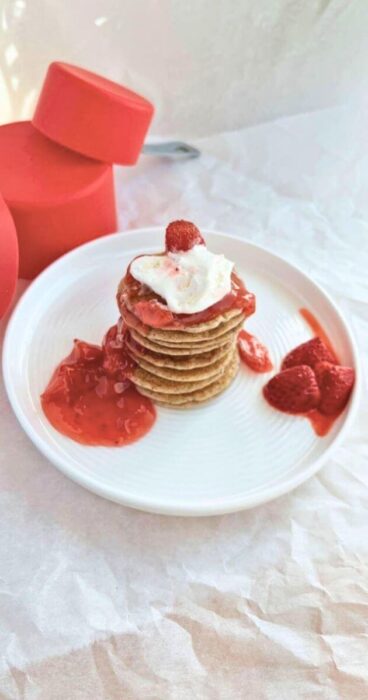 Gluten-free sourdough discard pancakes with strawberries on a white plate