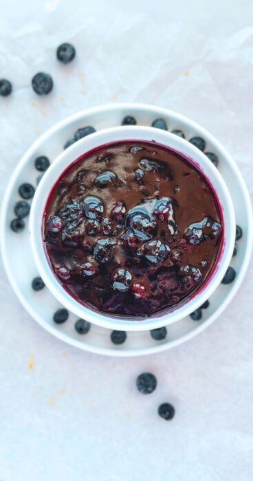A bowl of rich blueberry topping, perfect for gluten-free and dairy-free desserts.