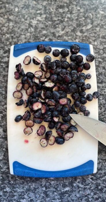 Sliced blueberries for a rich blueberry topping, a gluten free dairy-free treat.