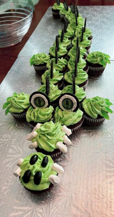 A cute creation depicting an alligator, made entirely of cupcakes.