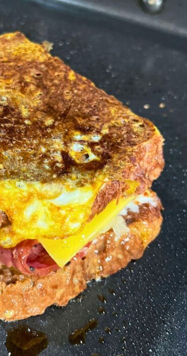 A gluten-free Reuben Monte Cristo sandwich, beautifully showcasing the golden brown egg coating.