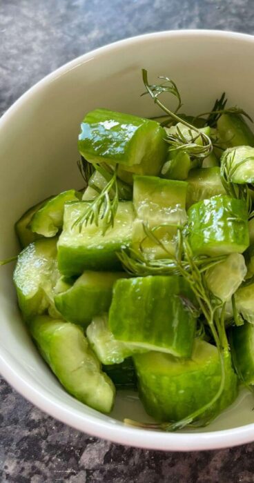 A refreshing bowl of smashed cucumbers tossed with vibrant dill, perfect for a gluten-free salad.