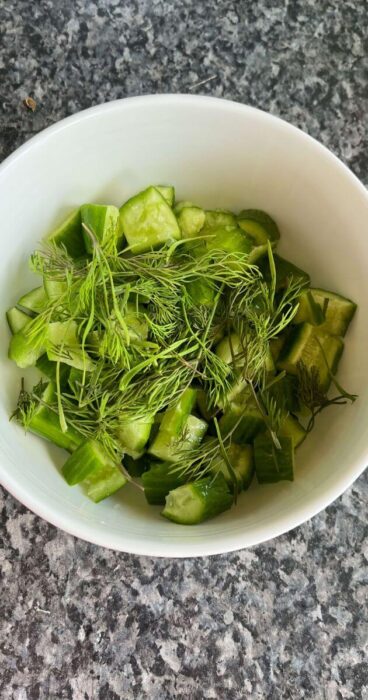 Close-up of smashed cucumbers topped with aromatic fresh dill for a delightful gluten free salad