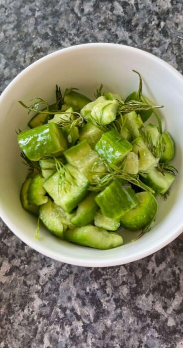 smashed cucumber pieces mixed with fresh dill and drizzled with a gluten-free dressing.