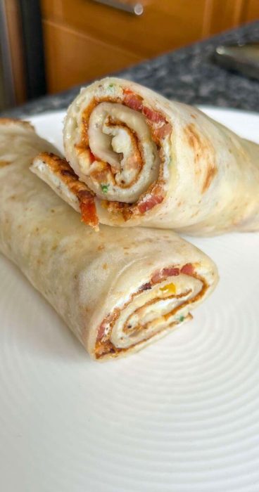 Egg omelet breakfast wrap in a gluten-free tortilla, perfect for a quick and easy meal.