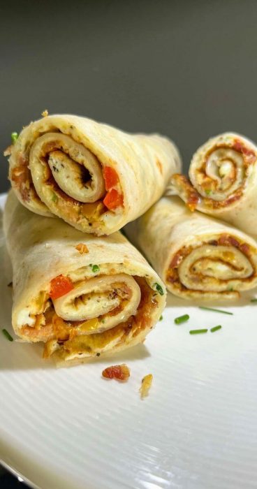 Delicious gluten-free tortilla wraps filled with savory omelets, crisp bell peppers, and bacon.