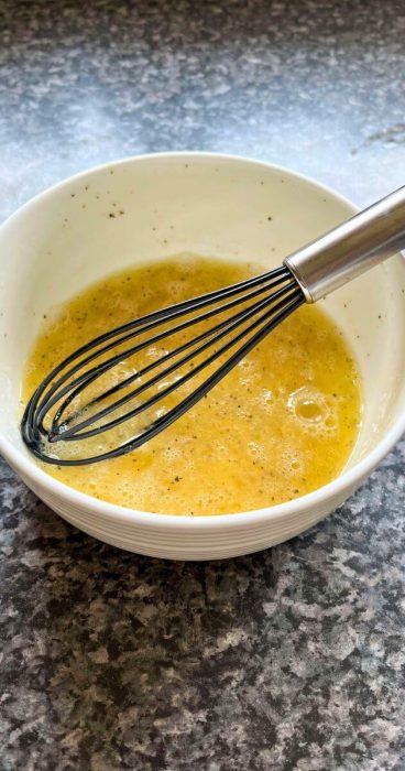 whisked eggs for a gluten-free omelet breakfast wrap in a soft tortilla